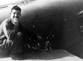 After returning to Liuzhou (Liuchow), China, Capt. Robert C. Pettingell, 491st Bomb Squadron Flight Leader, poses next to some of the damage received by the B-25J he was flying on a mission against White Cloud airfield near Canton in the spring of 1944.  (Info courtesy Tony Strotman)