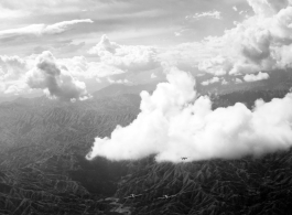 B-25 Mitchell bombers in flight over mountains in the CBI during WWII.