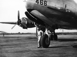 GI stands before a C-54 transport plane in the CBI.    From the collection of David Firman, 61st Air Service Group.