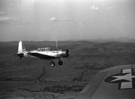 A  Vultee SNV-2 (a variant of the BT-13) trainer off the wing of another SNV-2, piloted by Charles Breingan, over China during WWII.