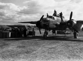 Maintenance personnel move across upper surfaces during pre-mission servicing of a B-25H 'gunship' of the 11th Bomb Squadron (not Group), 341st Bomb Group at Yang Tong Airfield, Guilin in Guangxi province, China. Circa fall of 1944.