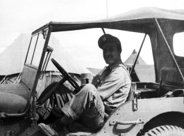 An American serviceman sits in a jeep, presumably a member of the 27th Troop Carrier Squadron, in the CBI.