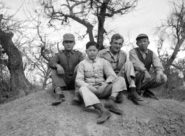 Yunnan (China), three young men employed as housekeepers and launderers sitting with Bert Krawczyk: "These are three houseboys from the airbase at Luliang. Houseboys were provided by the Chinese government under a reverse lend-lease program. The China War Area Service Command administered the program. This command was set up by Madame Chiang Kai-Shek to take care of the food and housing needs of American servicemen in China, who were considered guests by the Chinese government."