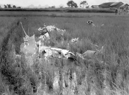GIs look over devastating crash site of an American aircraft--the bent .50 cal machine gun in one image indicates it is American, and the gun mounting is like that of the nose gun of some B-25 Mitchells.  In this image set, the intensity by which people are searching the crash site, and the solemn nature of it all, makes one wonder if they are not looking for human remains.