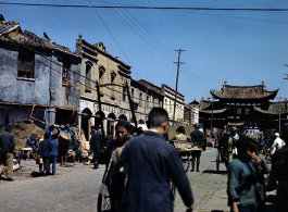 Street and markets near "Emerald Chicken" 碧鸡 and "Golden Horse" 金马 gates in Kunming during WWII, usually considered a pair: Golden Horse And Emerald Rooster Archway (金马碧鸡坊).  In the CBI during WWII.