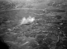 Smokes rises above village, likely in Burma, but possibly in either SW China, or French Indochina during WWII.