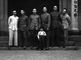A group of local soldiers--likely a local militia or local KMT-affiliated warlord soldiers-- in Yunnan, China, during WWII. They are standing before a temple.