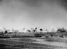 Japanese bombing of Kunming, December, 1943. The dirt pyramids are bomb bunkers.