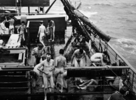 Nude men bathing on transport ship home from CBI to US after WWII.