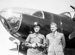 Two American flyers with A-26C Invader warplane. Seymour Mazer on the left.  The 491st began converting to the A-26 in late July 1945. However, the 491st planes would likely not have been all black (i.e., a night intruder aircraft) which typically was not done until Korea-era. Mazer would have been navigator, the other officer wears pilot's wings.  (Thanks Tony Strotman for additional info.)