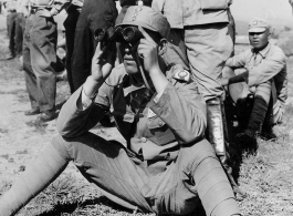 Two Chinese officer students of the General Staff School, near Kunming, China, observing the effect of mortar fire on distant target during a demonstration of infantry weapons.  June 5, 1945.  Photo by Pfc. Seymour Israel. 164th Signal Photographic Company, APO 627.