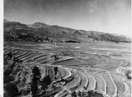 Scenes in Kunming, China, area during WWII: Terraced farmland, and boatmen waiting for commuter fares.