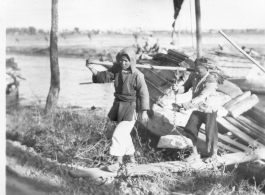 Scenes in Kunming, China, area during WWII: Boy with ox, and people getting off boat on canal.