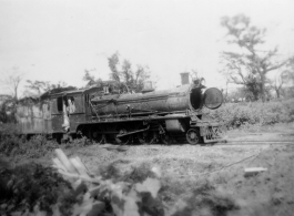 A shot up steam railroad engine, showing large number of bullet or shrapnel holes, derelict in Burma.  During WWII.  797th Engineer Forestry Company.