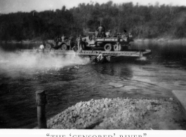 Trucks on ferry on river in Burma.  During WWII.  797th Engineer Forestry Company.