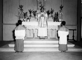 Services at a church in Burma. A western priest leads the ceremony.  In Burma near the 797th Engineer Forestry Company.  During WWII.