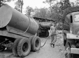 797th Engineer Forestry Company in Burma, GI fuels logging truck along the Burma Road.  During WWII.