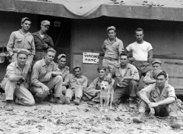 Engineers of the 797th Engineer Forestry Company pose before a building with the sign "VIRGINS HOME" in camp in Burma.  During WWII.