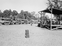 A convoy loaded with troops and engineers prepares to set out, while a band plays, and music projected to convoy via loudspeakers.  During WWII.