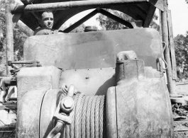 Bulldozer with cable for pulling log in Burma.  797th Engineer Forestry Company in Burma.  During WWII.
