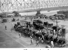 Rickshaw pullers and carriages await at Howrah Bridge in Calcutta, India, as seen by 2005th Ordnance Maintenance Company, 28th Air Depot Group, in India during WWII.