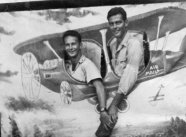 ATC flyers Lt. Bob Boswell and Richard Harris pose in fake prop airplane wall in India, during WWII, in August 1945.