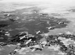 B-25s of the 22nd Bombardment Squadron in flight over rice paddies in SW China, French Indochina, or Burma during WWII.
