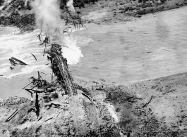 Aerial view of a railroad bridge just blown up by 22nd Bombardment Squadron in the CBI.