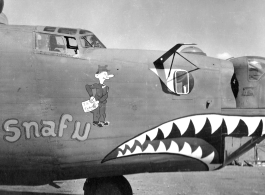 B-24 "Snafu," in CBI during WWII. The GI figure is holding a paper labeled "T. S. Ticket."