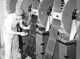 Film drying at photo lab of the 24th Mapping Squadron. June 10, 1944.