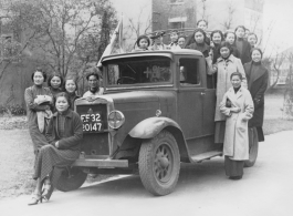Alice Chong sitting on the bumper of a British truck in Shanghai in February or March of 1938. 