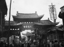 Street scene in Kunming, China, and arch with "天开云瑞"坊. During WWII.