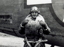 American flyer Gérard Labrie with B-24 bomber "80 Days" during WWII. Note his heavy clothing and parachute.