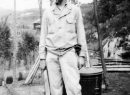 Douglas Runk holding a machete in SW China during WWII.