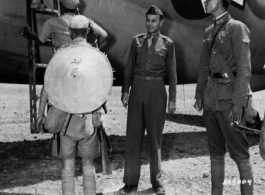 Maj. William H. Makepeace, left, G-3, Y-FOS, and Capt. Shao Lien watch Chinese troops of the Chinese Fifth Army Group board a plane at the Kunming Airport during a troopp movement by air.  Kunming, China, 9/69/44