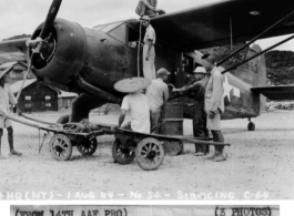 Chinese workers help service a C-64, loading fuel by hand crank, on August 1, 1944, somewhere in the China. 
