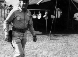 GI walks in front on a tent in India during WWII.  From the collection of David Firman, 61st Air Service Group.
