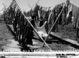 Chinese workers at an American base hang out the base laundry to dry in the sun, during WWII.  August 3, 1944
