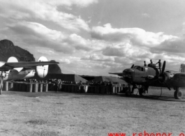 Refueling aircraft, B-25 on the right and B-24 on the left, at Liuzhou or Guilin, in Guangxi.  From the collection of Hal Geer.