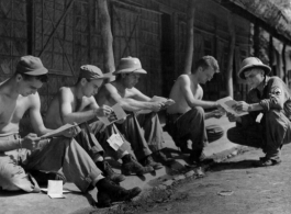Enlisted men who have been fortunate enough to receive mail from home take time out to read their letters.  Kurmitola Army Air Base, India, 1943.  In the CBI during WWII.