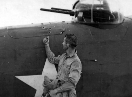 Bullet holes in the fuselage of the North American B-25 after a mission that ended in a forced landing on one wheel at its base in China.  December 12, 1942.