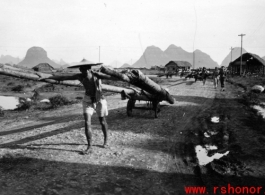 A Chinese laborer hauling logs in Guangxi province in southwest China, during WWII, in 1945.