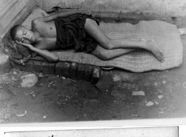 Impoverished Chinese man sleeping, Kunming, china, June 1945.