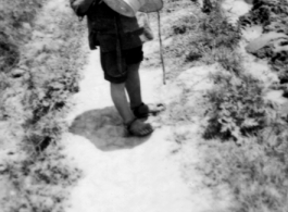 A small boy on a path amongst farm fields near Kunming, China, May 1945.