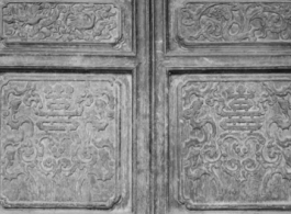 A carved wooden door panel in China. During WWII.  From the collection of Frank Bates.