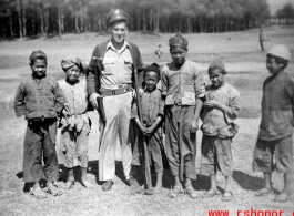 Walter Polchlopek with Chinese village kids in the area of Yangkai, Yunnan province, China, during WWII.