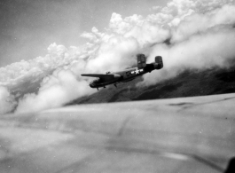 B-25 Mitchell bomber #439 in flight in the CBI, in the area of southern China, Indochina, or Burma.