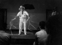 Celebrities visit and perform at Yangkai, Yunnan province, during WWII: Performer does a rope act for  the GIs, as caught by Wozniak in long-exposure photography.