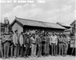 10CU 567 36 BURMA ROAD (RES). Soldiers at ease in China, waiting for arrival of a convoy over the Burma Road or listening to a commemorative speech about the opening of the road. A movie camera is set to go on the truck to the right.