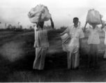 Men carrying laundry in India during WWII.  Local images provided to Ex-CBI Roundup by "P. Noel" showing local people and scenes around Misamari, India.  